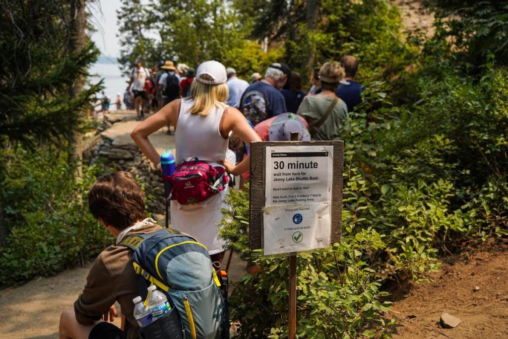Grand Teton National Park visitors wait in line for the Jenny Lake boat shuttle