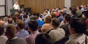 People listening to a speaker at a conference