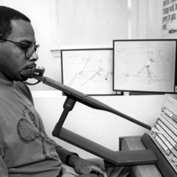 Graduate student Vincent L. Haley demonstrating his pointer device for computer accessibility