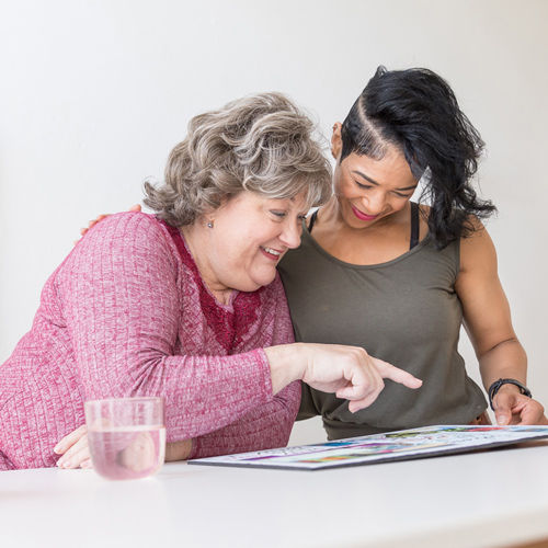 two health and wellness coaches reviewing materials