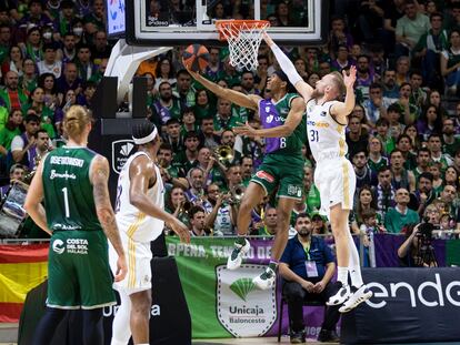 El jugador del Unicaja Kameron Taylor entra a canasta ante la defensa de Dejan Musa, del Real Madrid.