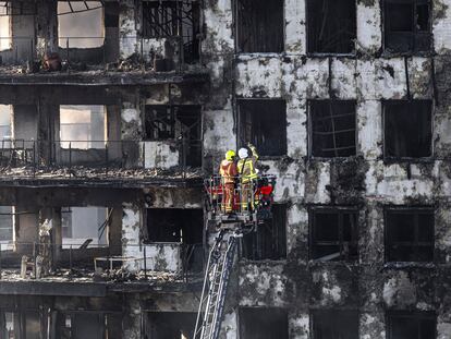 Un grupo de bomberos inspecciona la fachada de las torres incendiadas del barrio del Campanar.