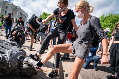 Manifestantes pisam na cabeça de uma estátua de Cristóvão Colombo em St. Paul, Minnesota, em junho de 2020.