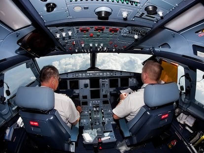 Pilotos de aerolínea en vuelo.