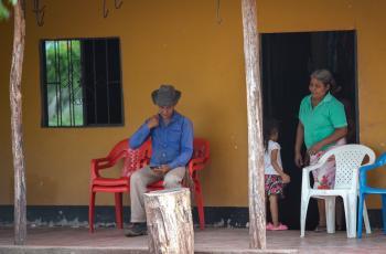 En La Junta, un corregimiento de Cesar, la tierra del cacique Diomedes Díaz, personas se sientan a las afueras de una casa para escuchar vallenato.