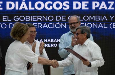 Vera Grabe (i), representante del gobierno, y Pablo Beltrán (d), del Eln, se dan la mano tras firmar la prórroga del cese el fuego en Cuba.