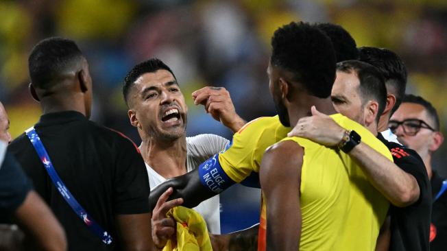 Uruguay's forward #09 Luis Suarez argues with Colombia's forward #09 Miguel Borja (R) at the end of the Conmebol 2024 Copa America tournament semi-final football match between Uruguay and Colombia at Bank of America Stadium, in Charlotte, North Caroline on July 10, 2024. (Photo by Chandan Khanna / AFP)