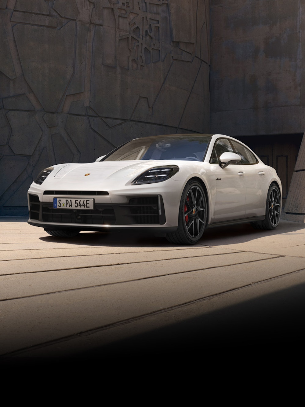 The new Porsche Panamera parked in front of a modern building.