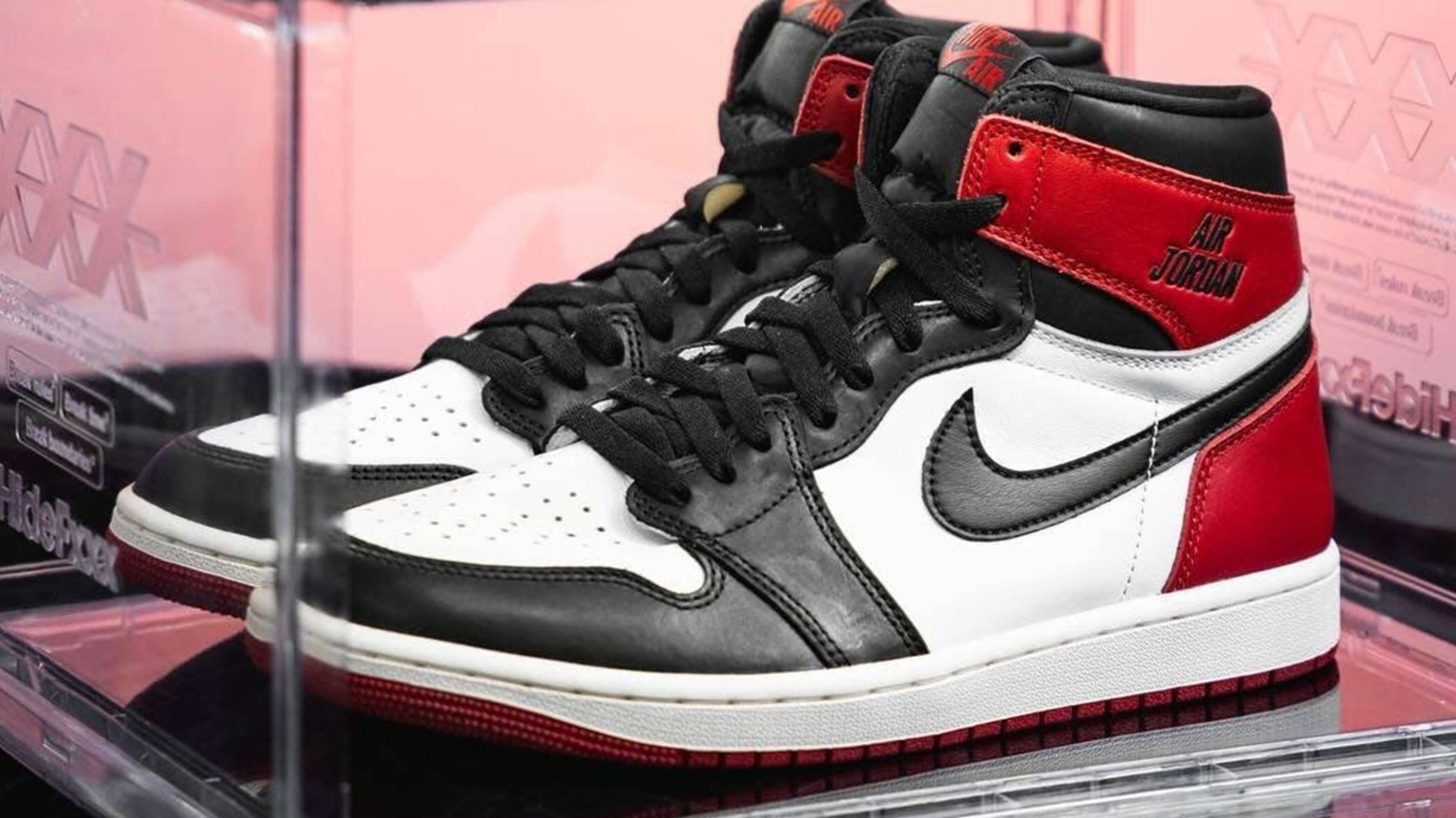 Air Jordan sneakers displayed in a clear case, likely a new or limited edition