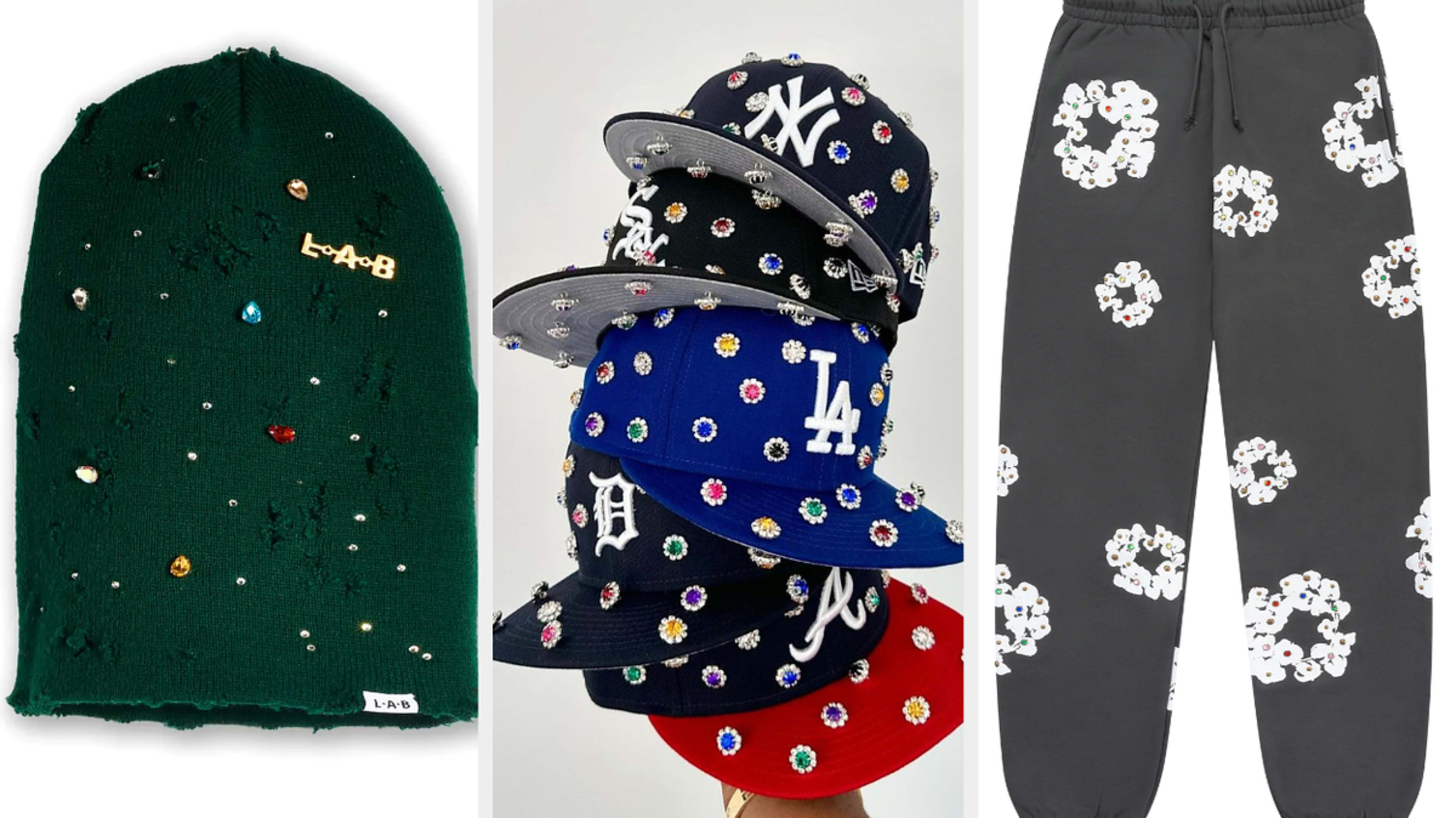 A collection of streetwear accessories including a beanie, stack of baseball caps with various logos adorned with jewels, and a pair of sweatpants with jewel designs