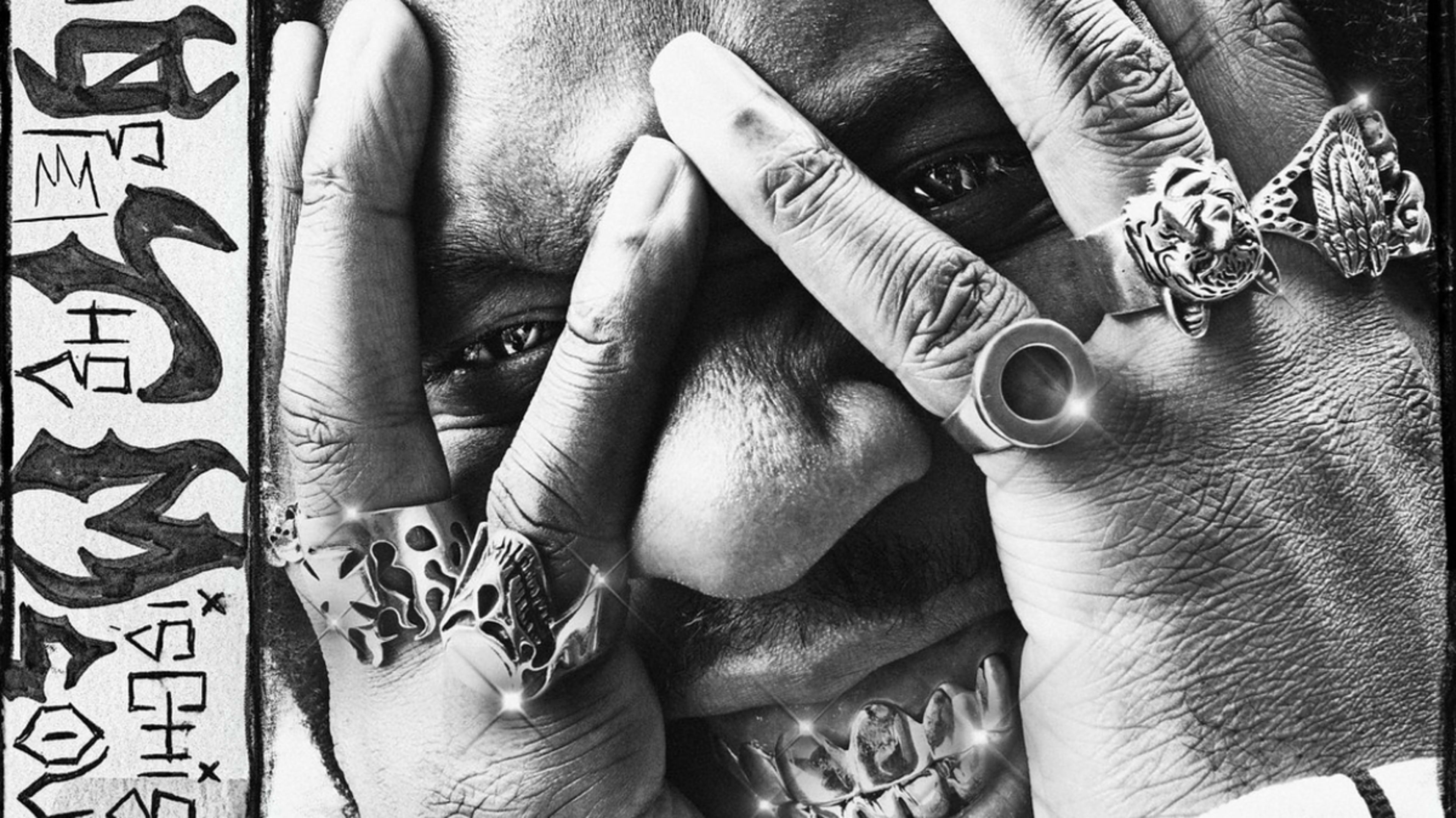 Burna Boy covers his face with his hands adorned with multiple rings in an intense close-up image. Text on the left appears to be artistic and stylized