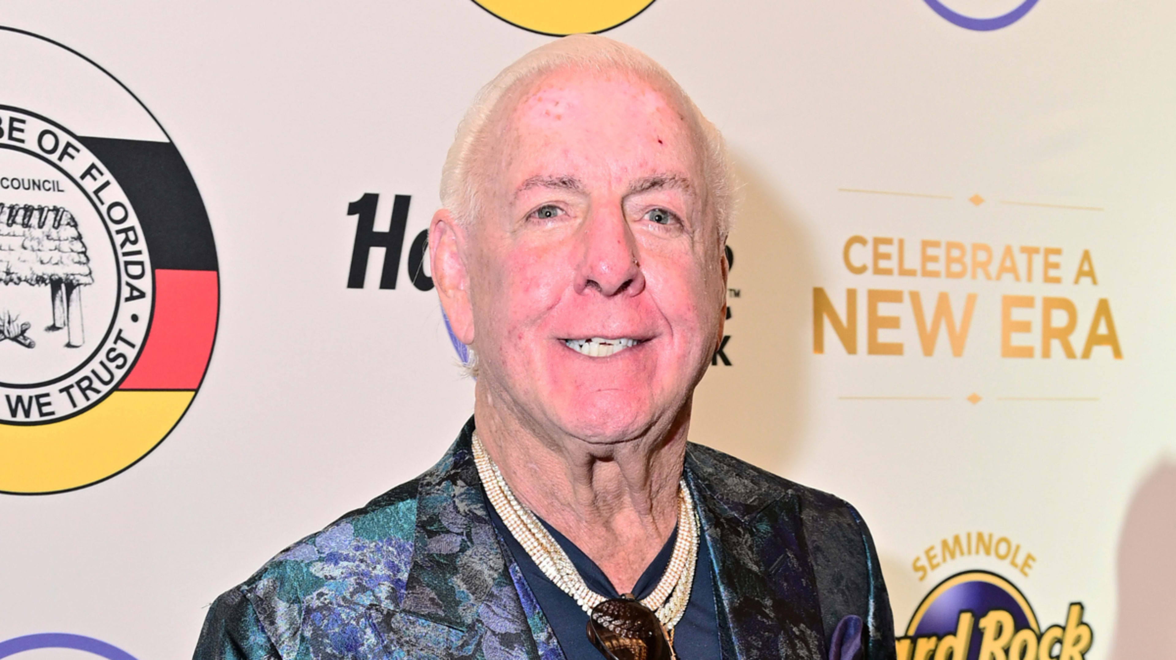 Man in patterned jacket posing at event; cannot name the individual