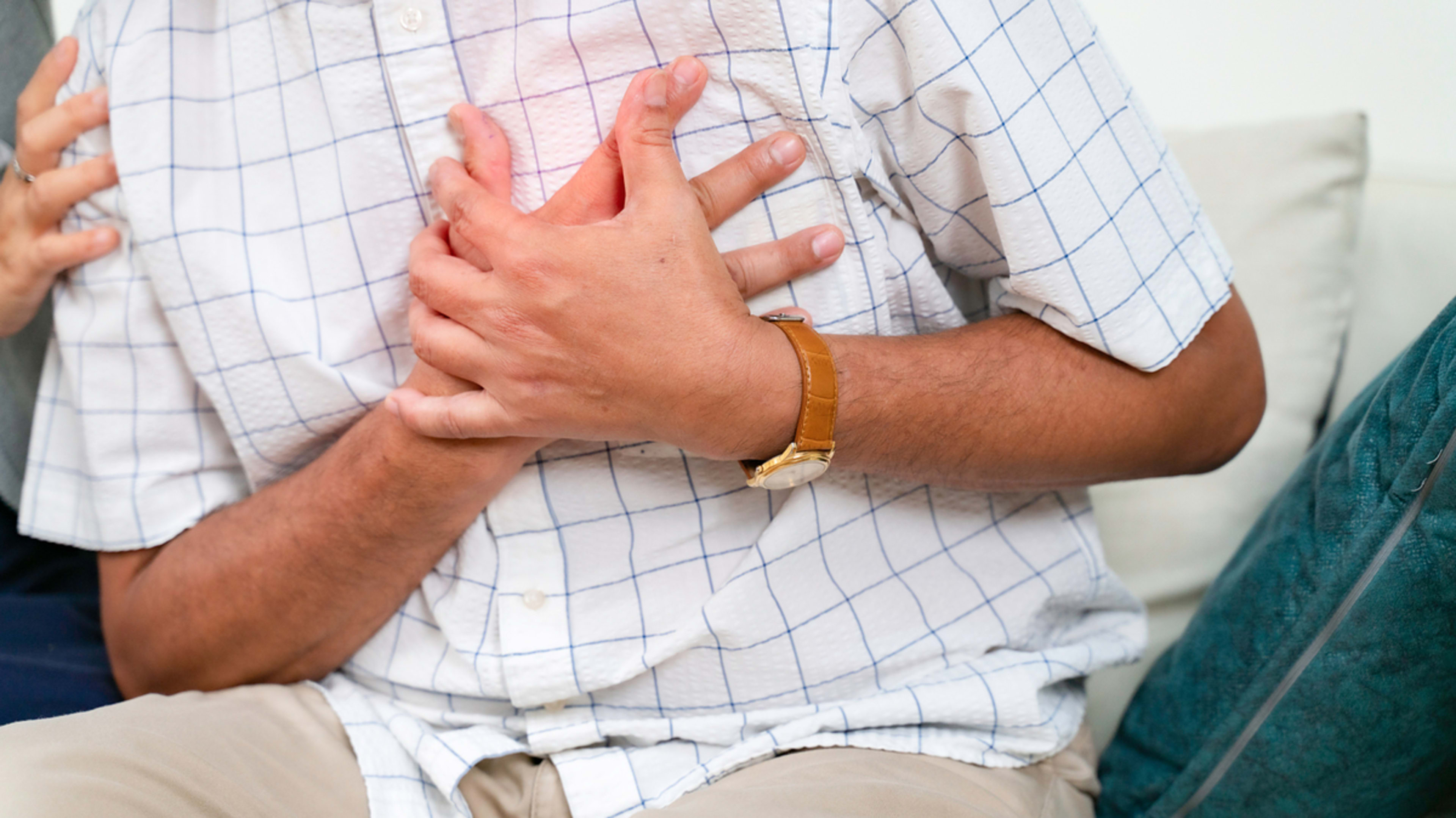 man holding chest in pain