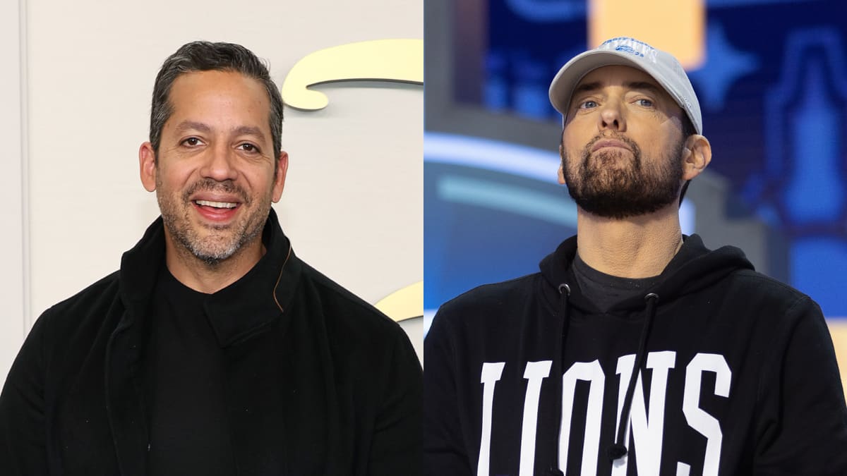 David Blaine (left) is smiling and wearing a black jacket over a black shirt. Eminem (right) is serious, wearing a "LIONS" hoodie and a grey cap