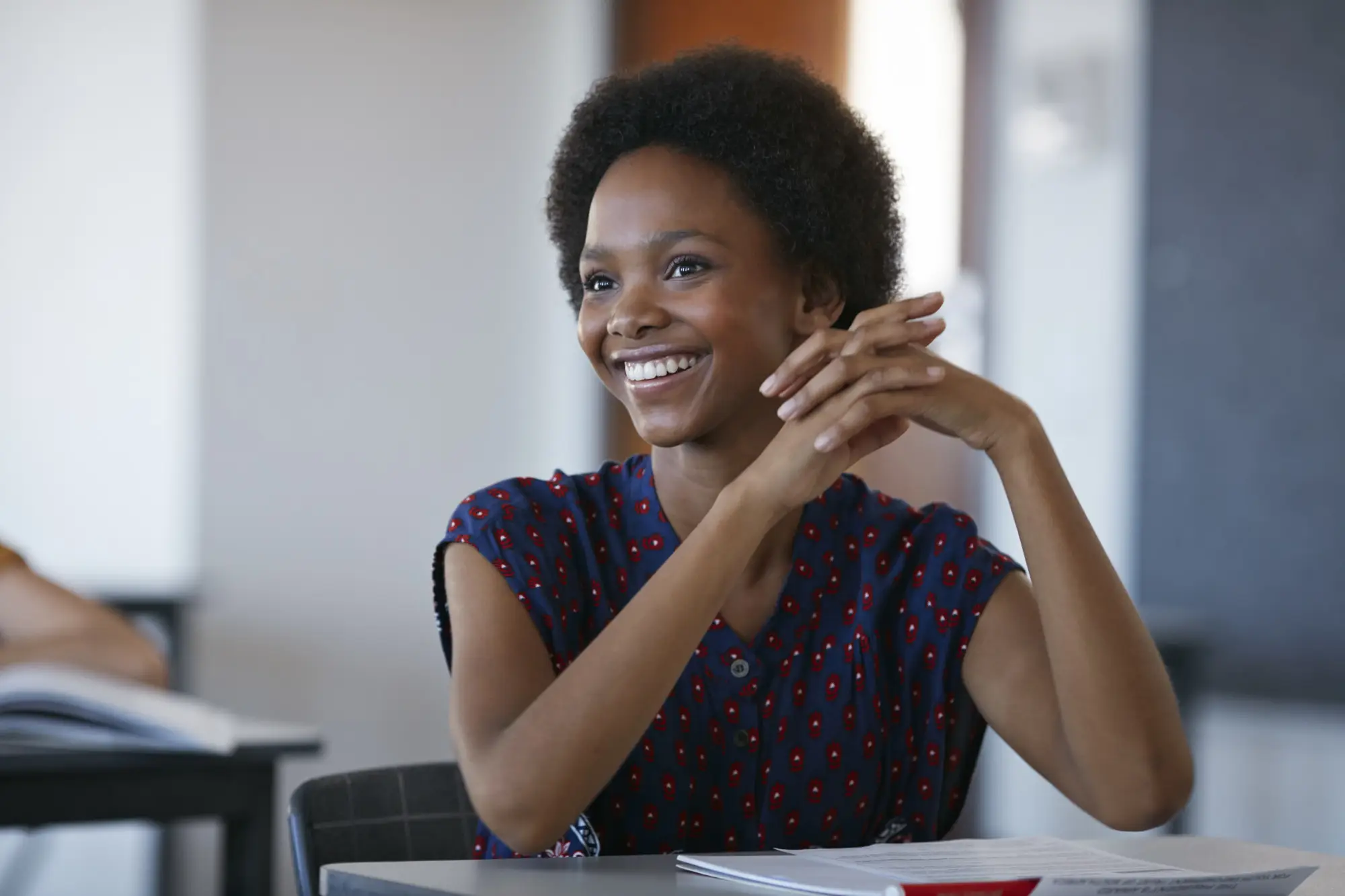 A smiling student in a classroom