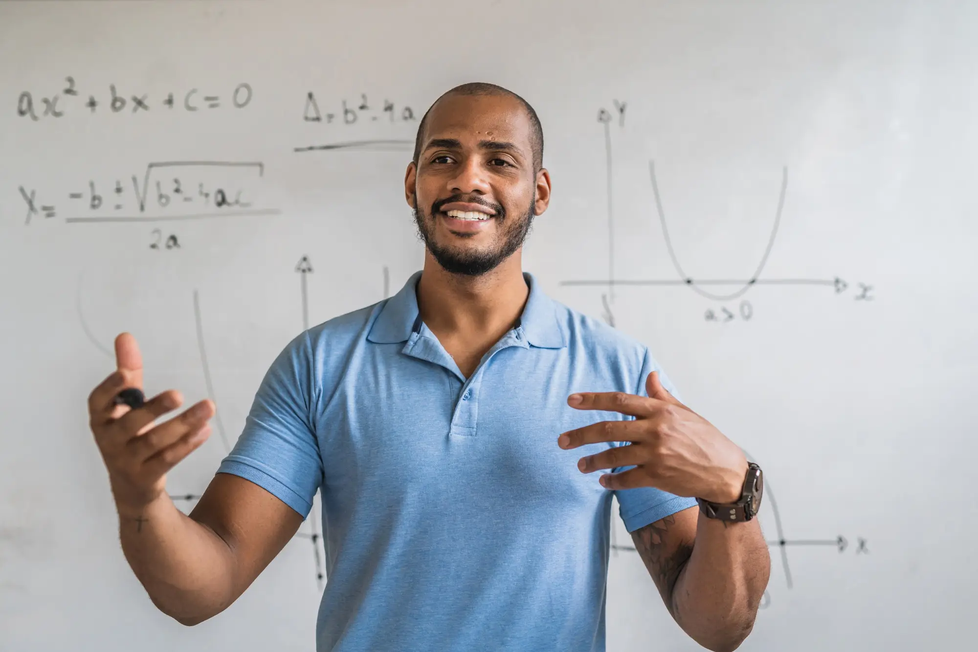 Student standing in front of a whiteboard 