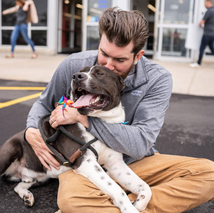 man hugging dog