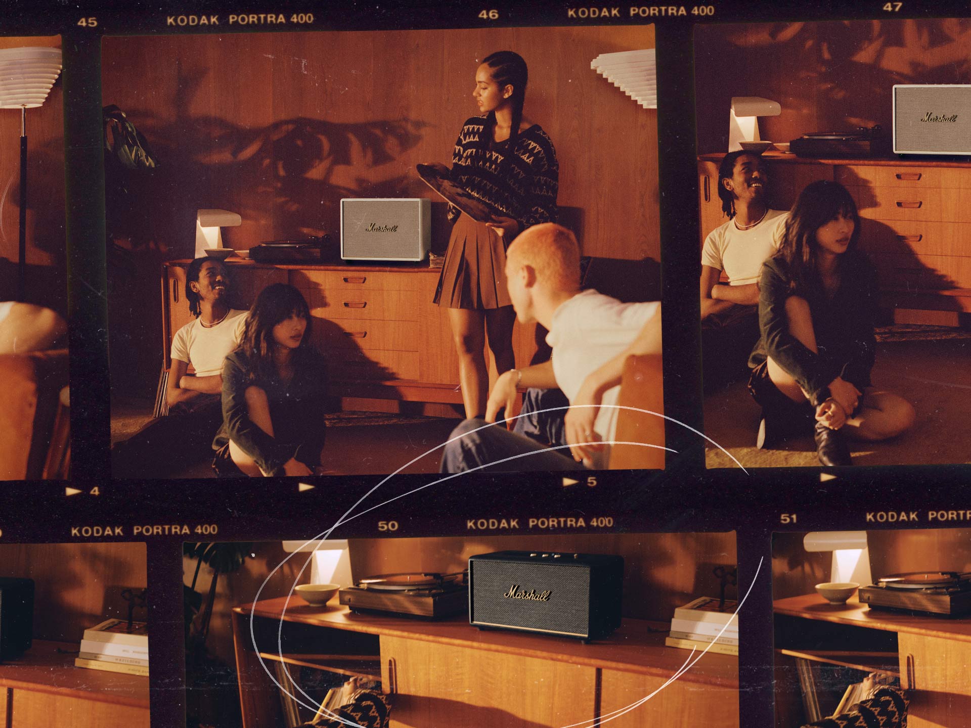 A group of people sitting and listening to music from a Marshall Home Speaker