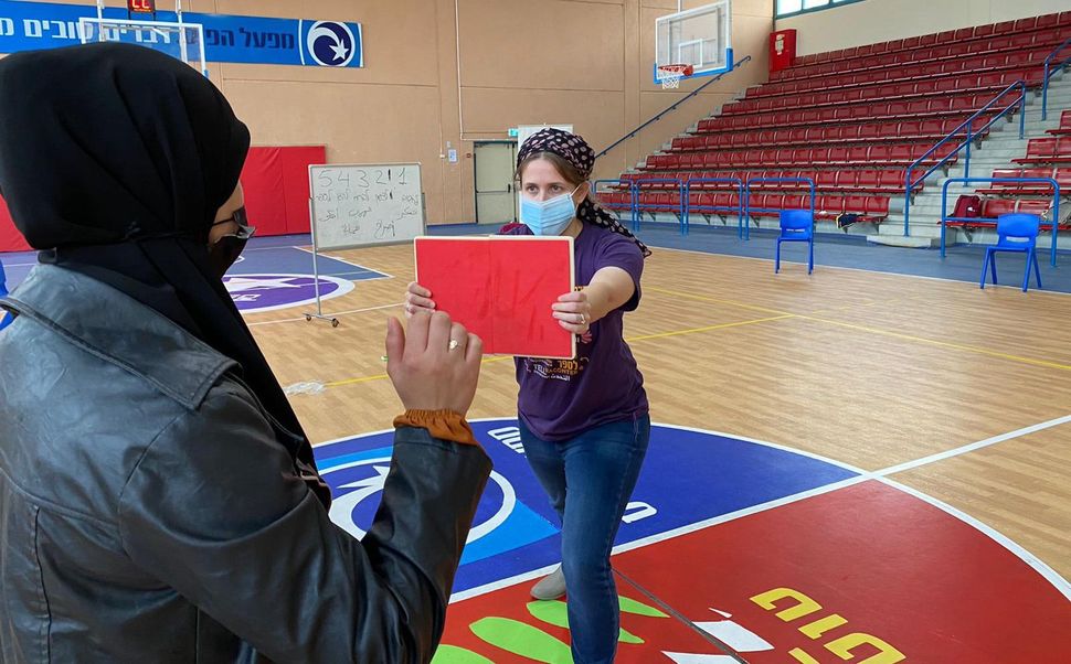 Two women, one Jewish and one Arab, participate in a self-defense course.