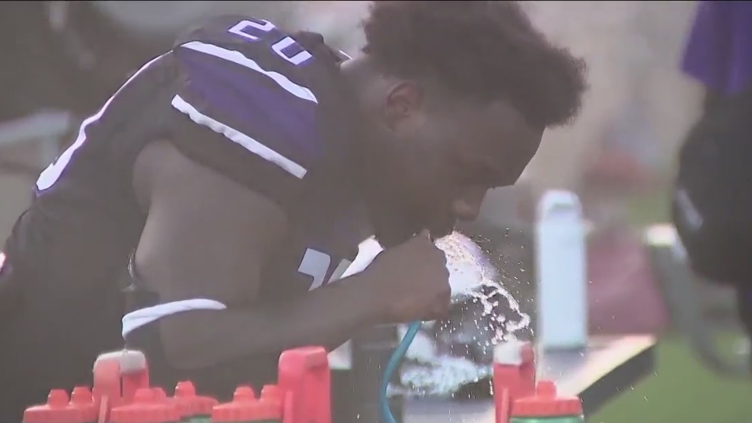 Fan battling high temperatures at high school football games