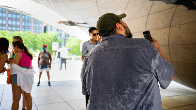 A man is seen with his shirt sweaty in downtown Chicago, the United States, on June 14, 2022. The Chicago metropolitan area is bracing for a heat wave, as the U.S. National Weather Service issued a heat advisory for the area on Monday.