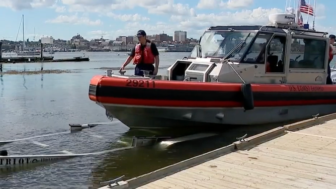 A boat that is about to be taken out of the water.