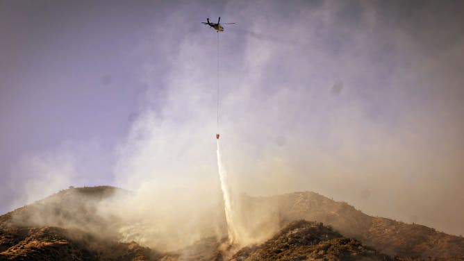 On Orwin road fire crews battle a hot spot at the Gorman Brush Fire in northern Los Angeles County on Sunday, June 16, 2024 in Gorman, CA. (Jason Armond / Los Angeles Times via Getty Images)