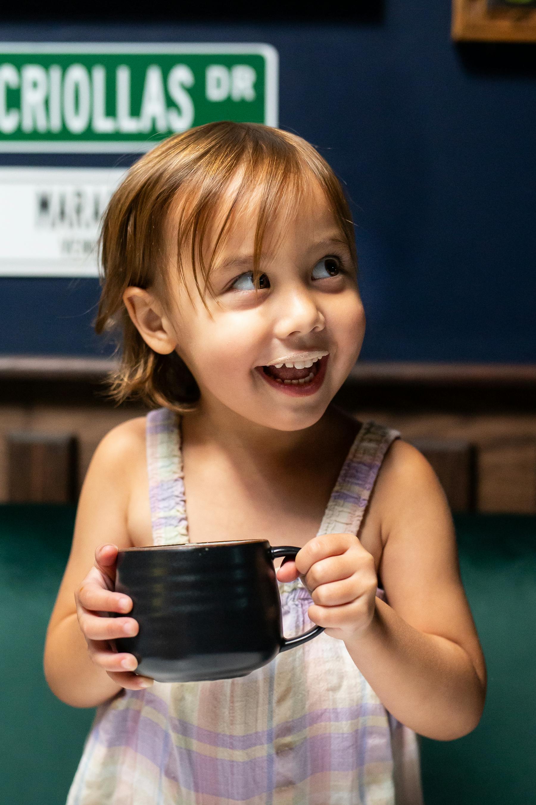 a little girl holding a cell phone