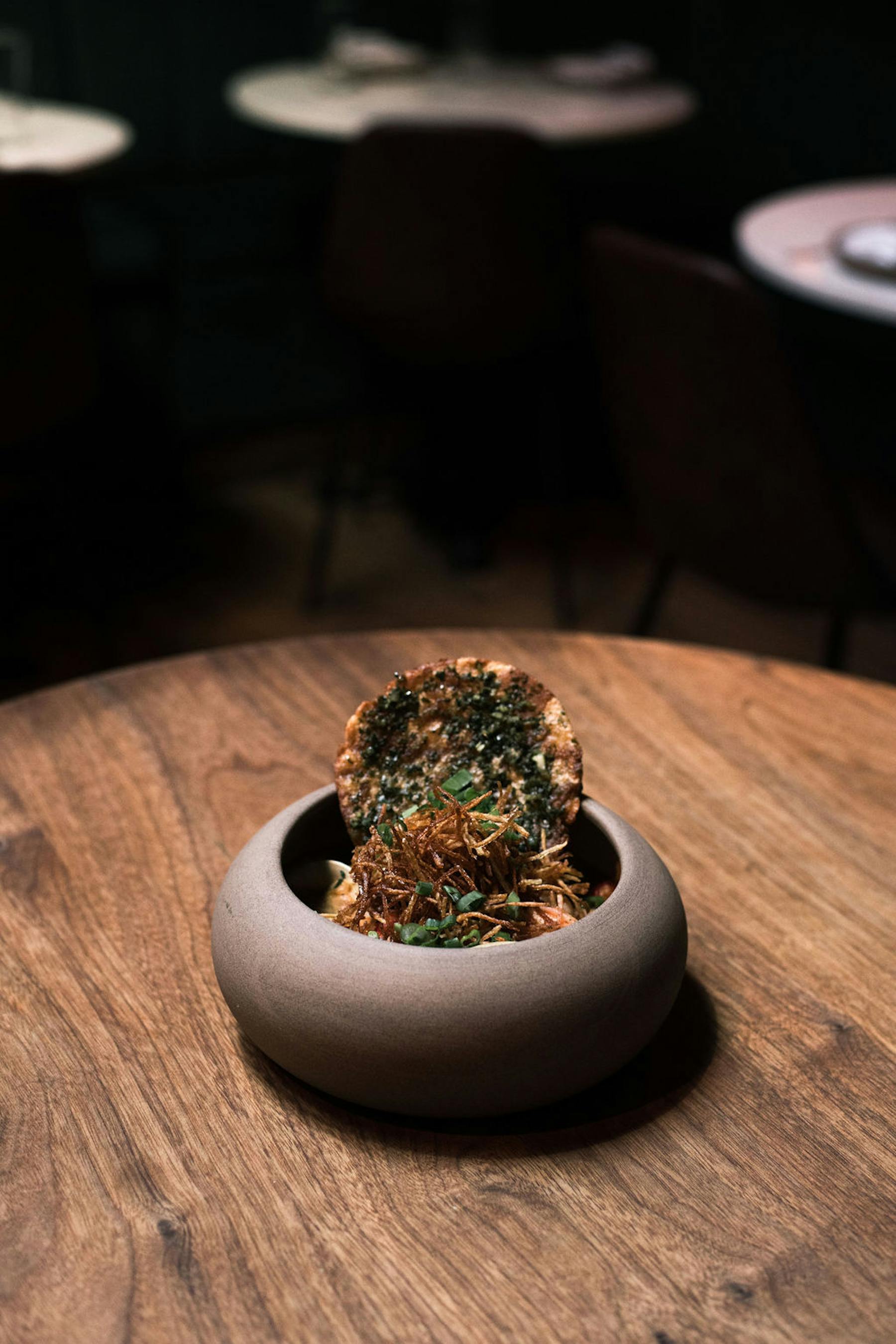 a close up of a doughnut sitting on top of a wooden table