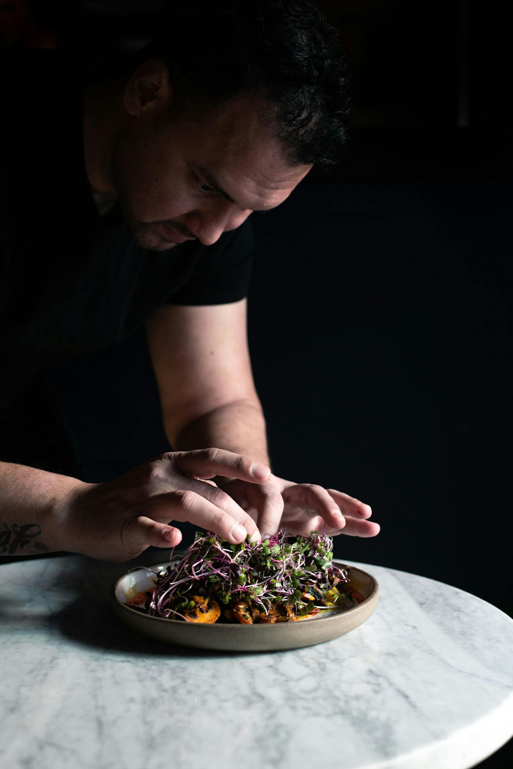 a person cutting food on a plate