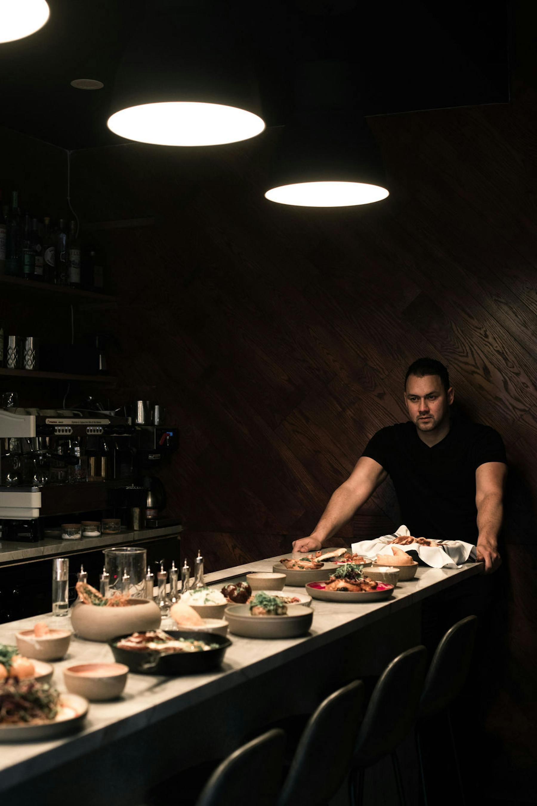 a person sitting on a kitchen counter preparing food