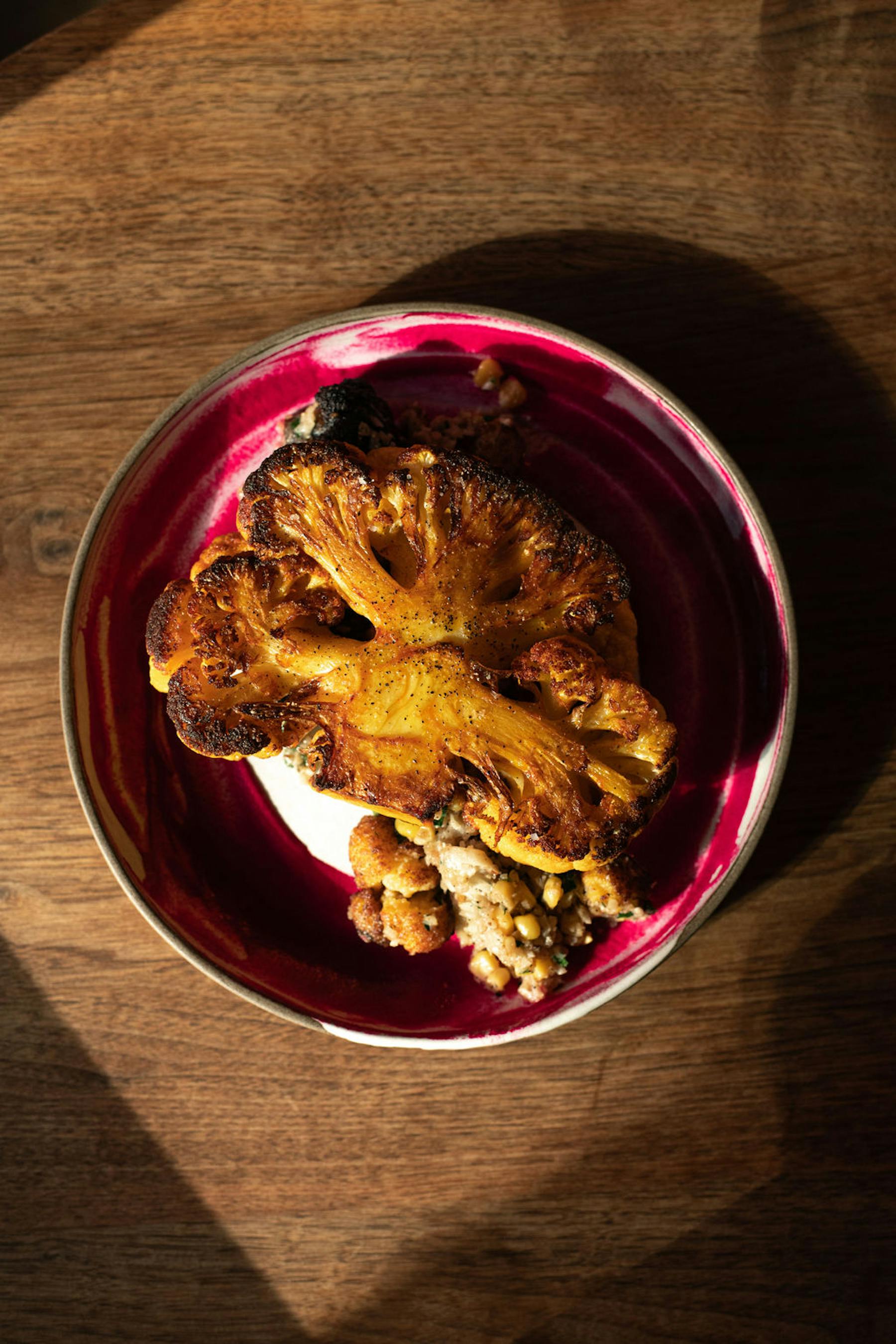 a bowl of food sitting on top of a wooden table