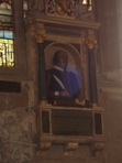The bust is on the left (north) wall behind the altar rail. It is so constantly being photographed, that it is hard to avoid the glare of other cameras. The blue central light in this image is caused by someone else's camera.