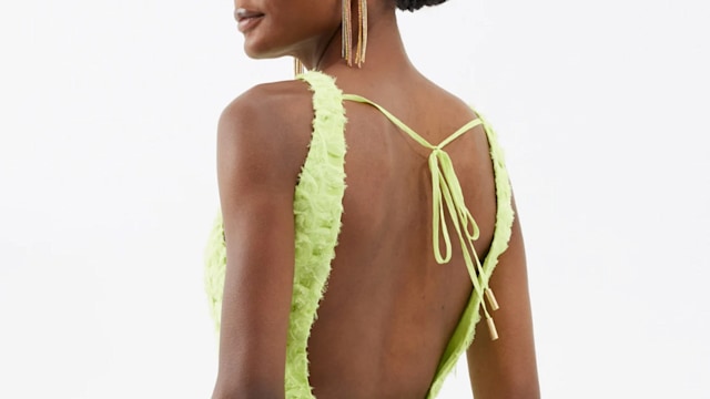 Model wearing pale green backless dress