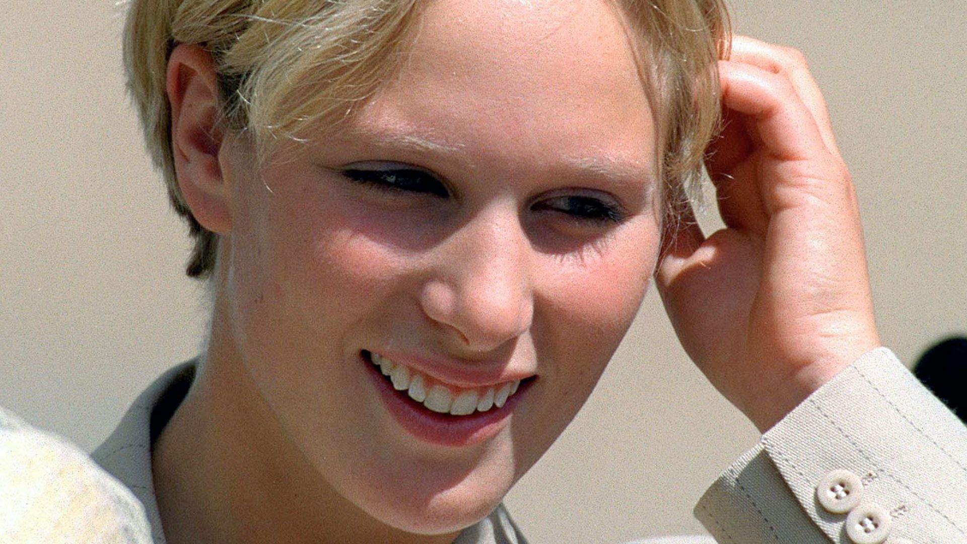 Zara Tindall pushing her pixie cut hair behind her ear