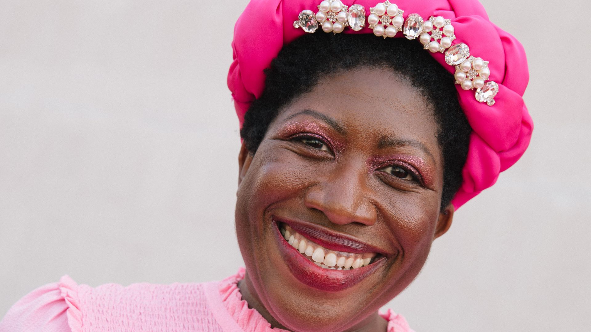 Ateh Jewel attends the 2023 BAFTA Television Awards in a pink hat and dress