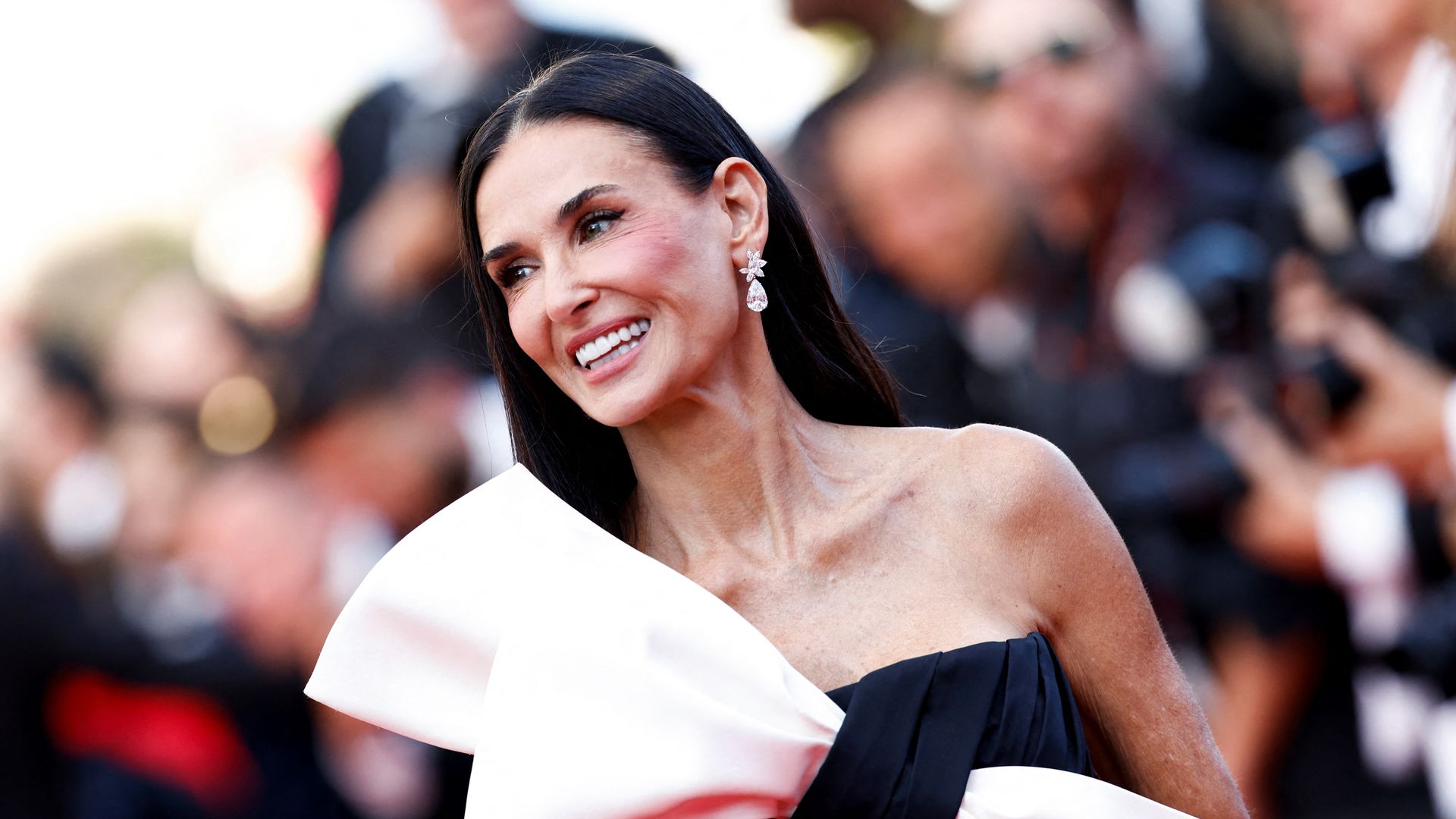 Demi Moore wearing a black and pink bow dress at Cannes