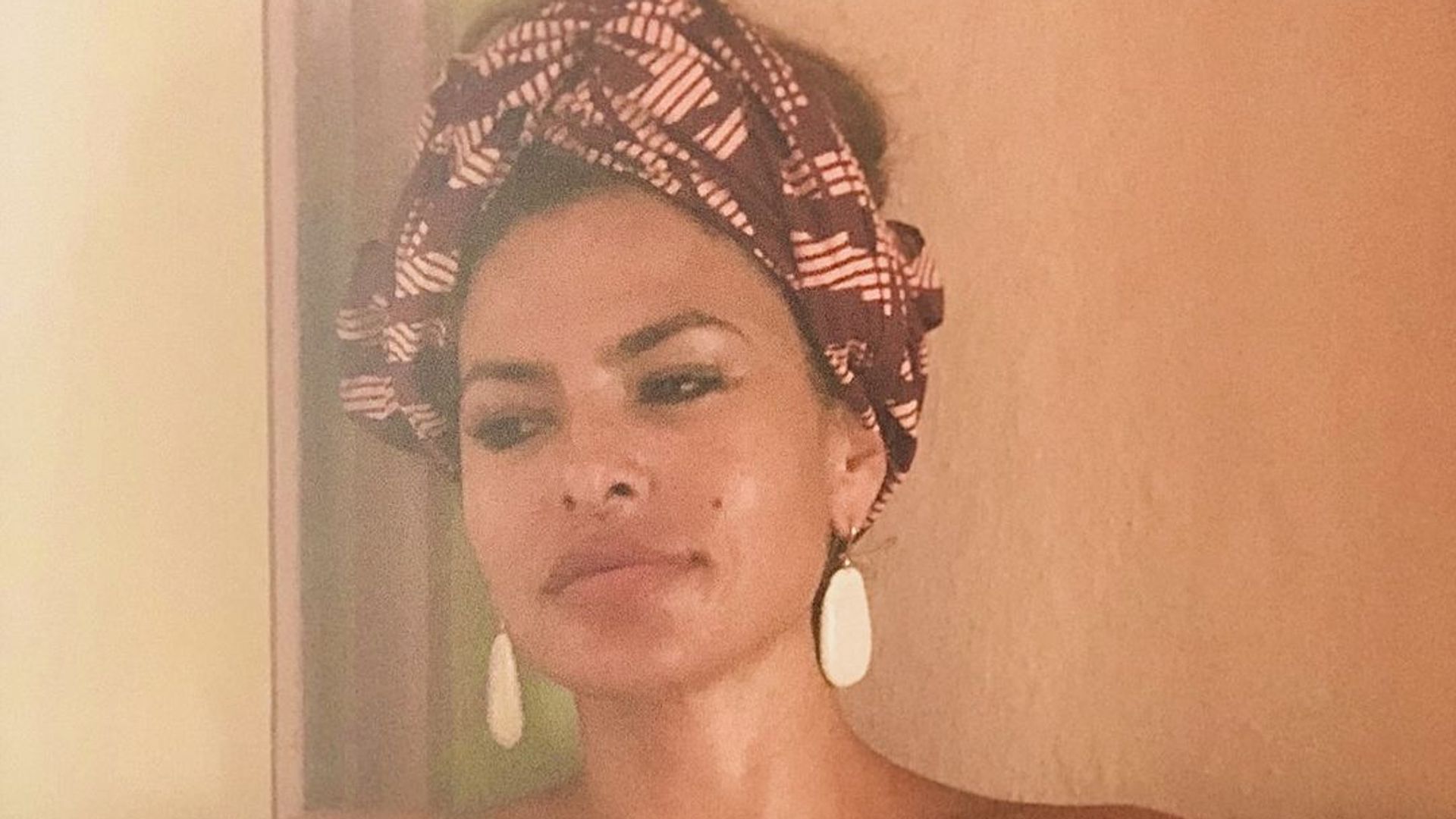 Eva Mendes dons a head band and a strapless dress