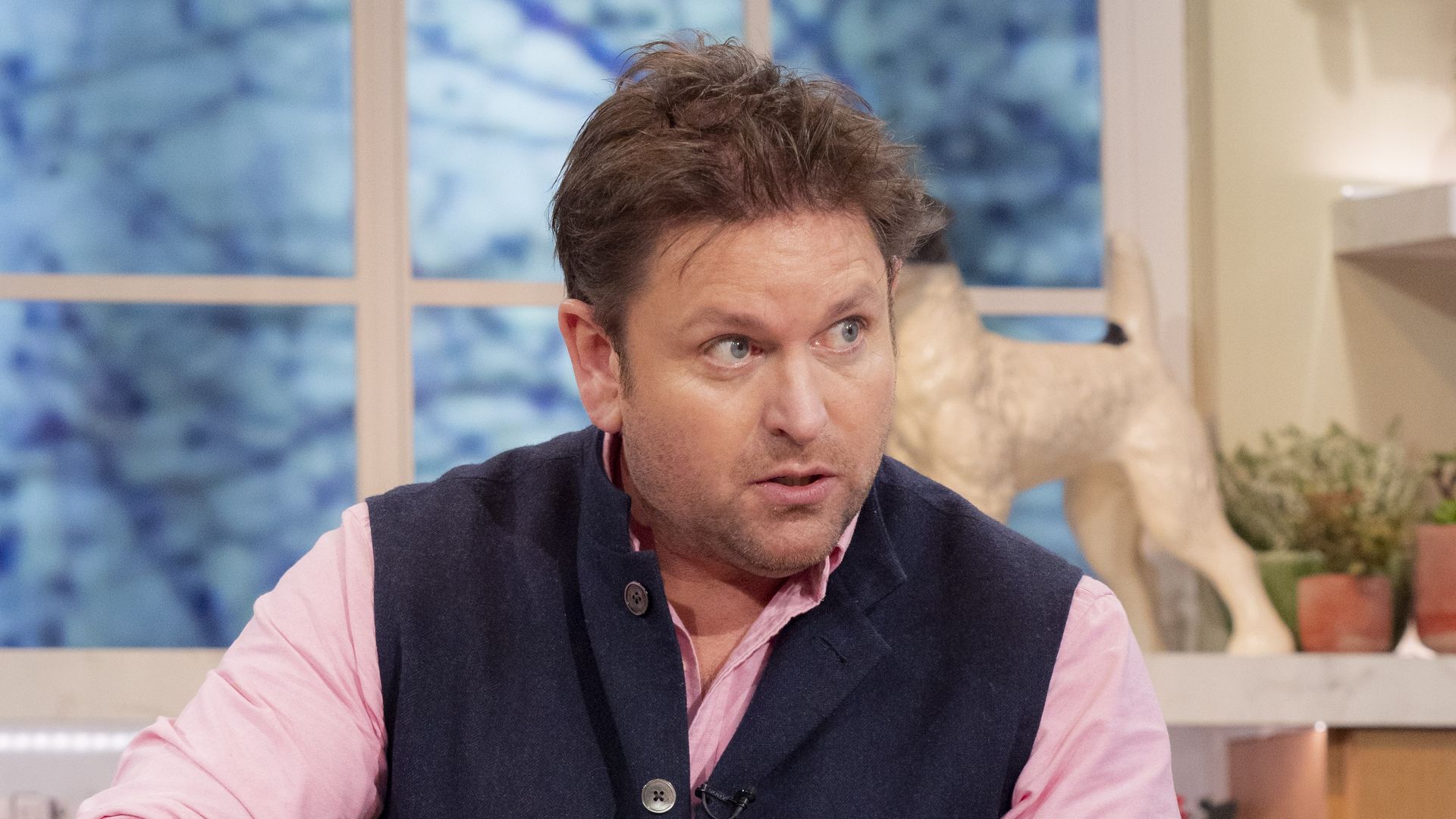 James Martin cooking food in a pink shirt and waistcoat