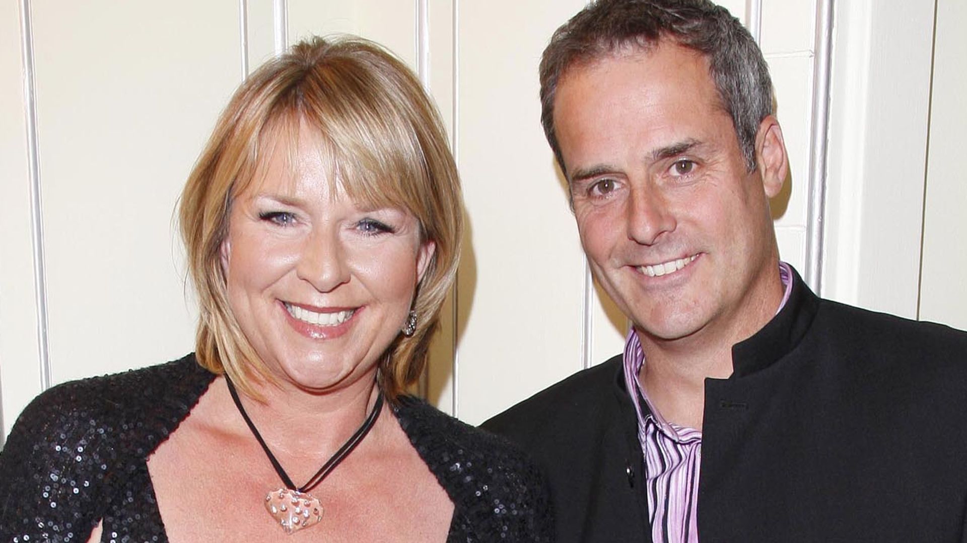 Fern Britton in a black dress alongside ex husband Phil Vickery in a suit