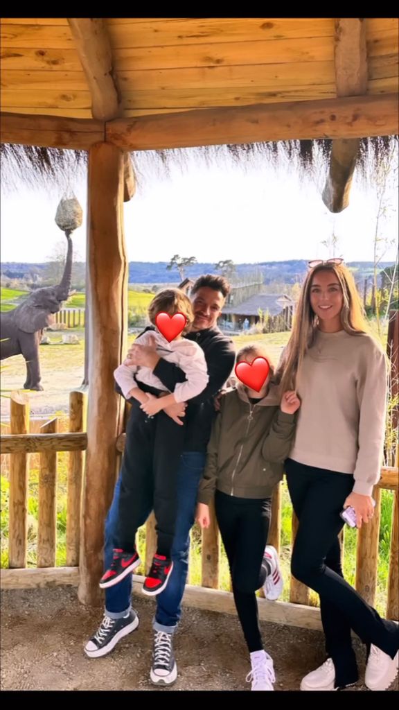 Peter and Emily posing for a photo with Theo and Amelia