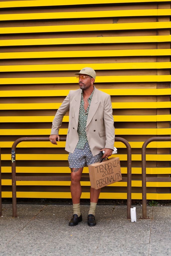 A guest wearing a beige baseball cap, a beige, double-breasted blazer is seen during Pitti Immagine Uomo 106 