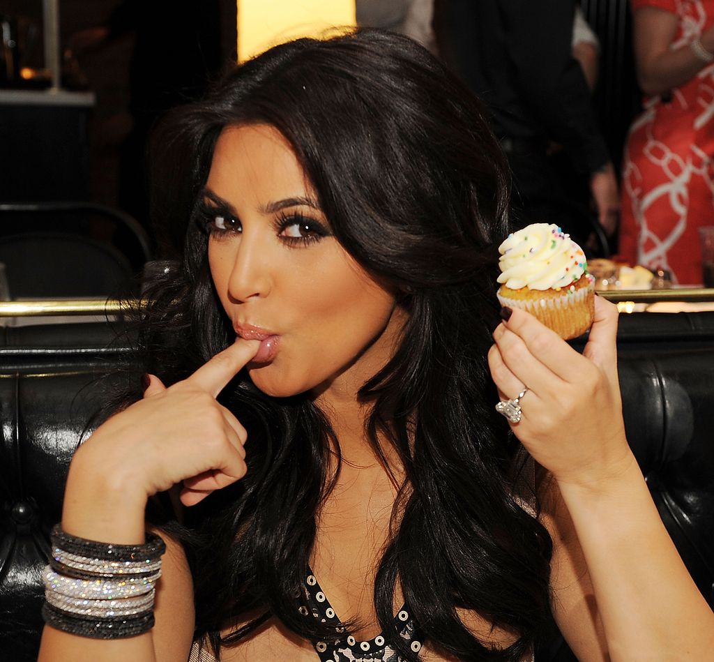 Kim Kardashian eating a cupcake in 2011