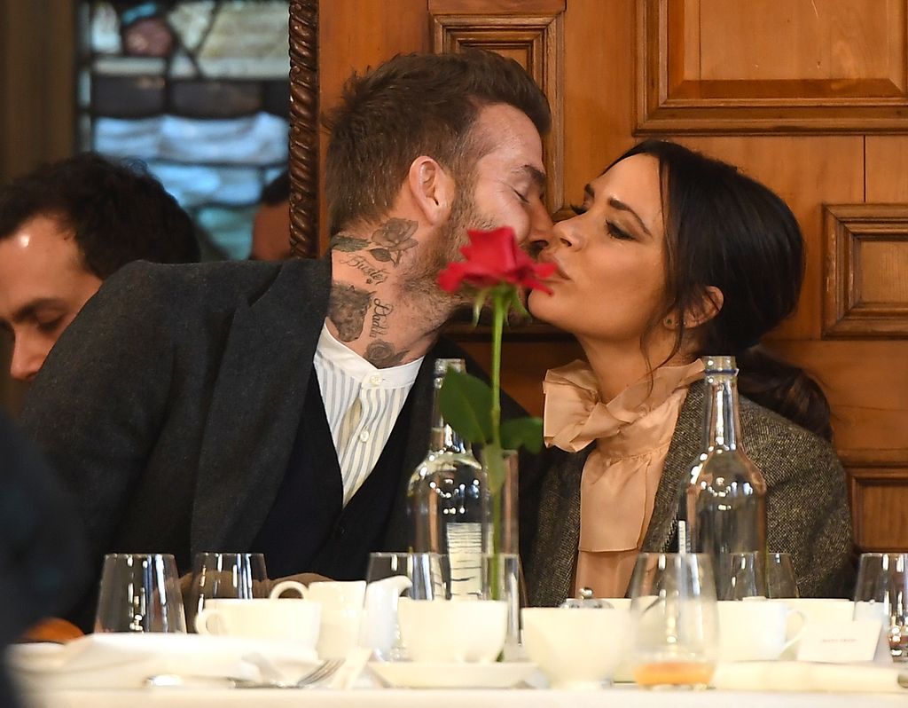 David Beckham kisses Victoria at the dinner table