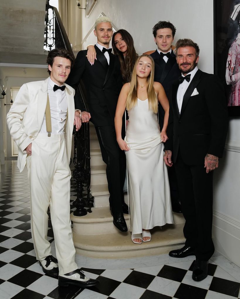 family posing on steps in home