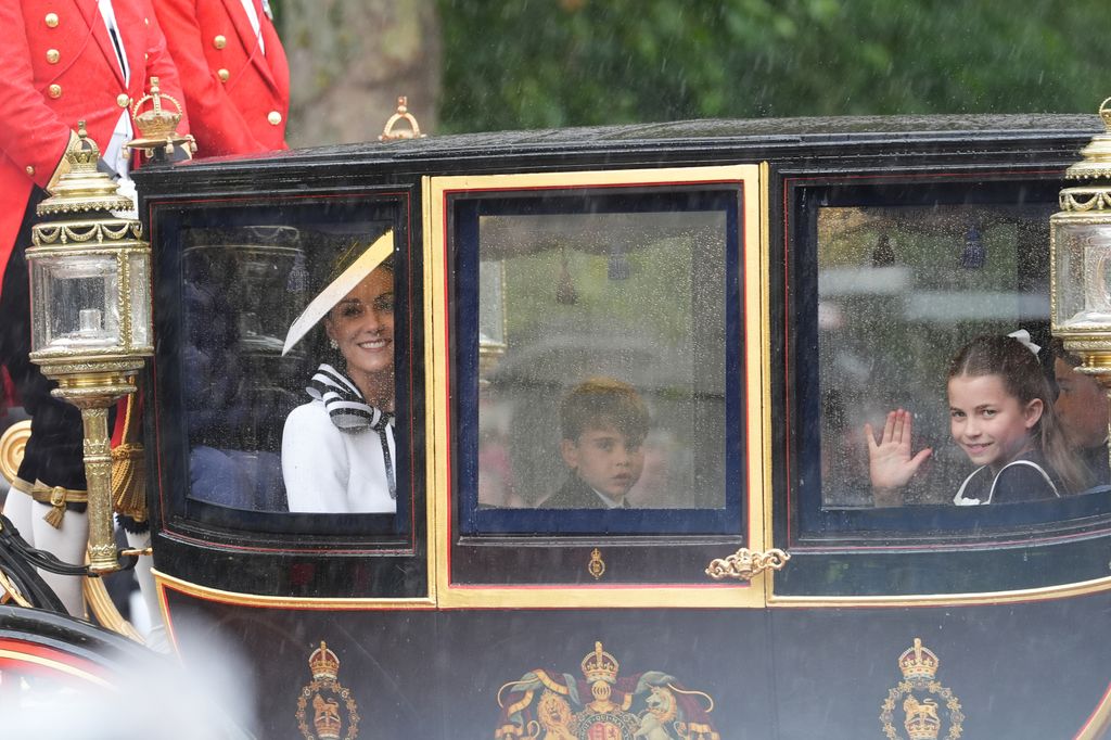 Princess Kate, Prince Louis and Princess Charlotte travel along The Mall after Trooping the Colour ceremony at Horse Guards Parade