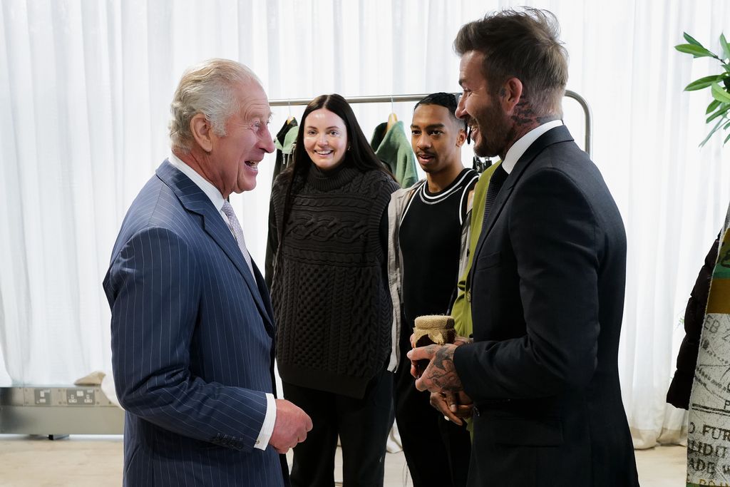 David Beckham handing a pot of honey to King Charles