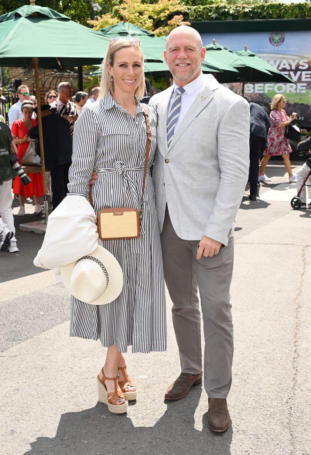 Zara Tindall stepped out with Mike Tindall wearing a striped shirt dress, a raffia bag from Aspinal of London and an elegant white boater.