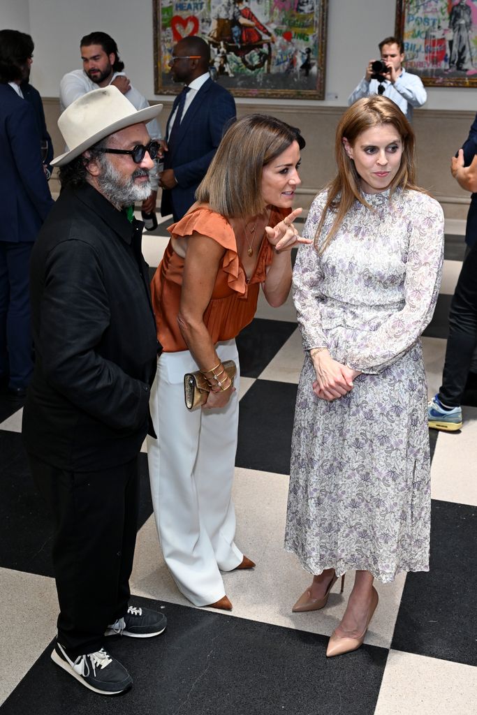 Princess Beatrice viewing art in floral dress