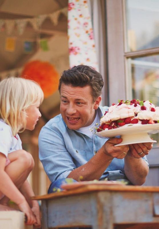 Jamie Oliver showing a young Buddy a cake